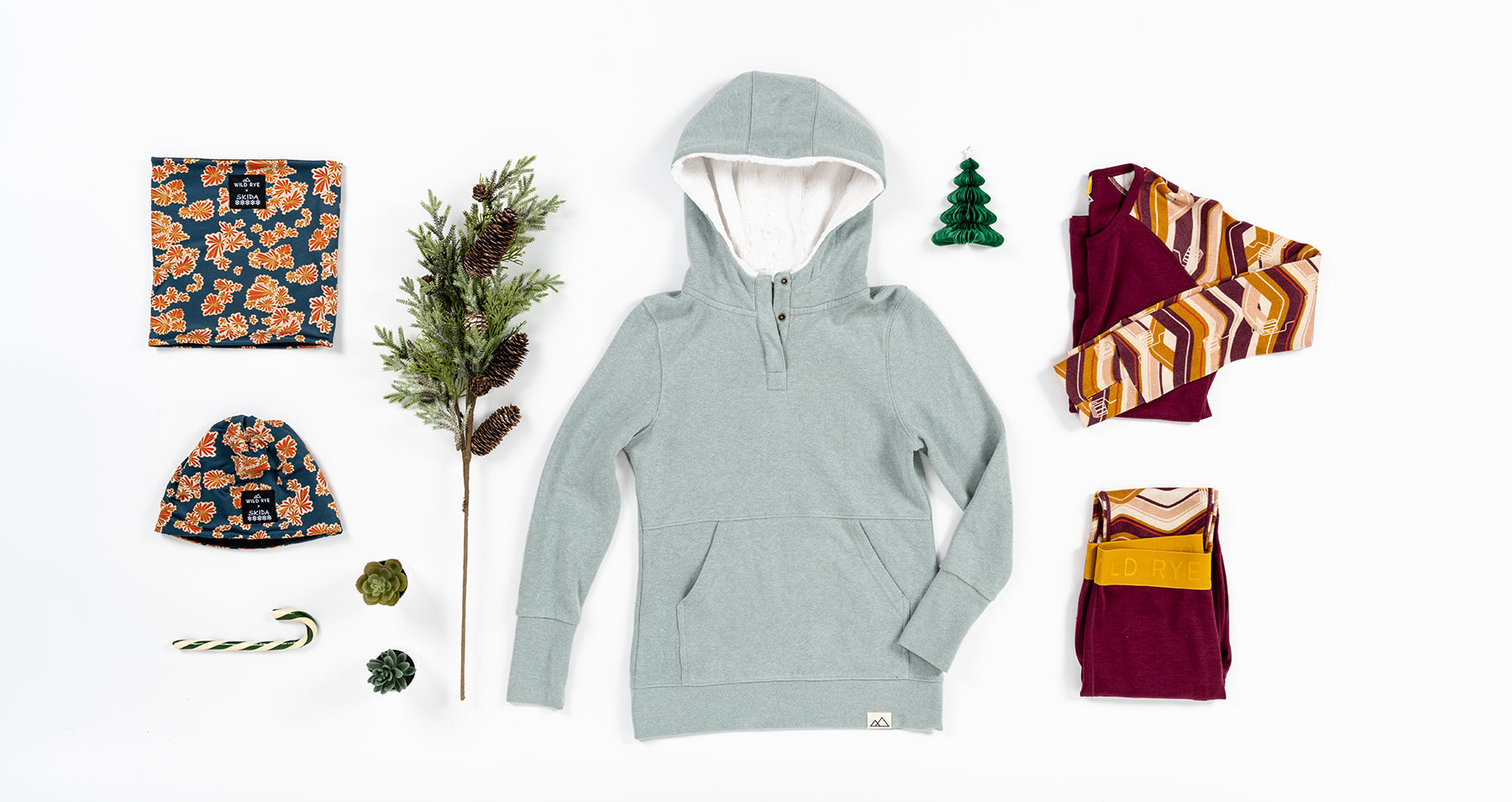 A collection of clothing and accessories for the Boss Babe Gift Guide, including a hoodie, leggings, and decorative items.