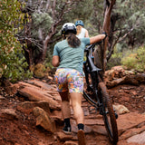 Woman Pushing Bike Uphill