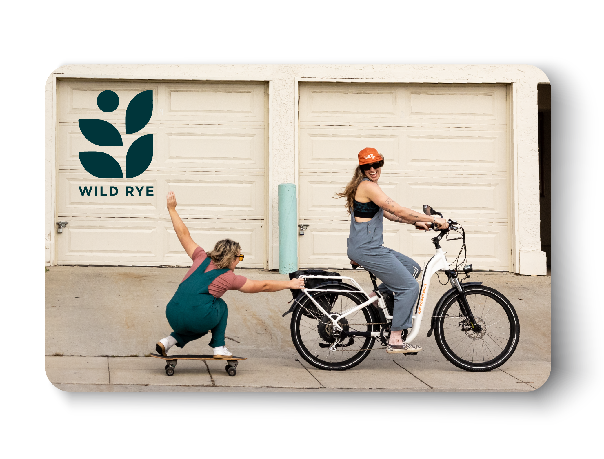 E-Gift Card mockup featuring a woman skateboarding behind a cruiser bike with Wild Rye logo