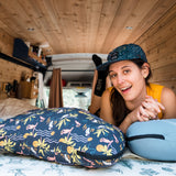 Woman using camping pillow in van