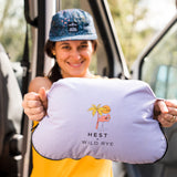 Woman holding out camping pillow