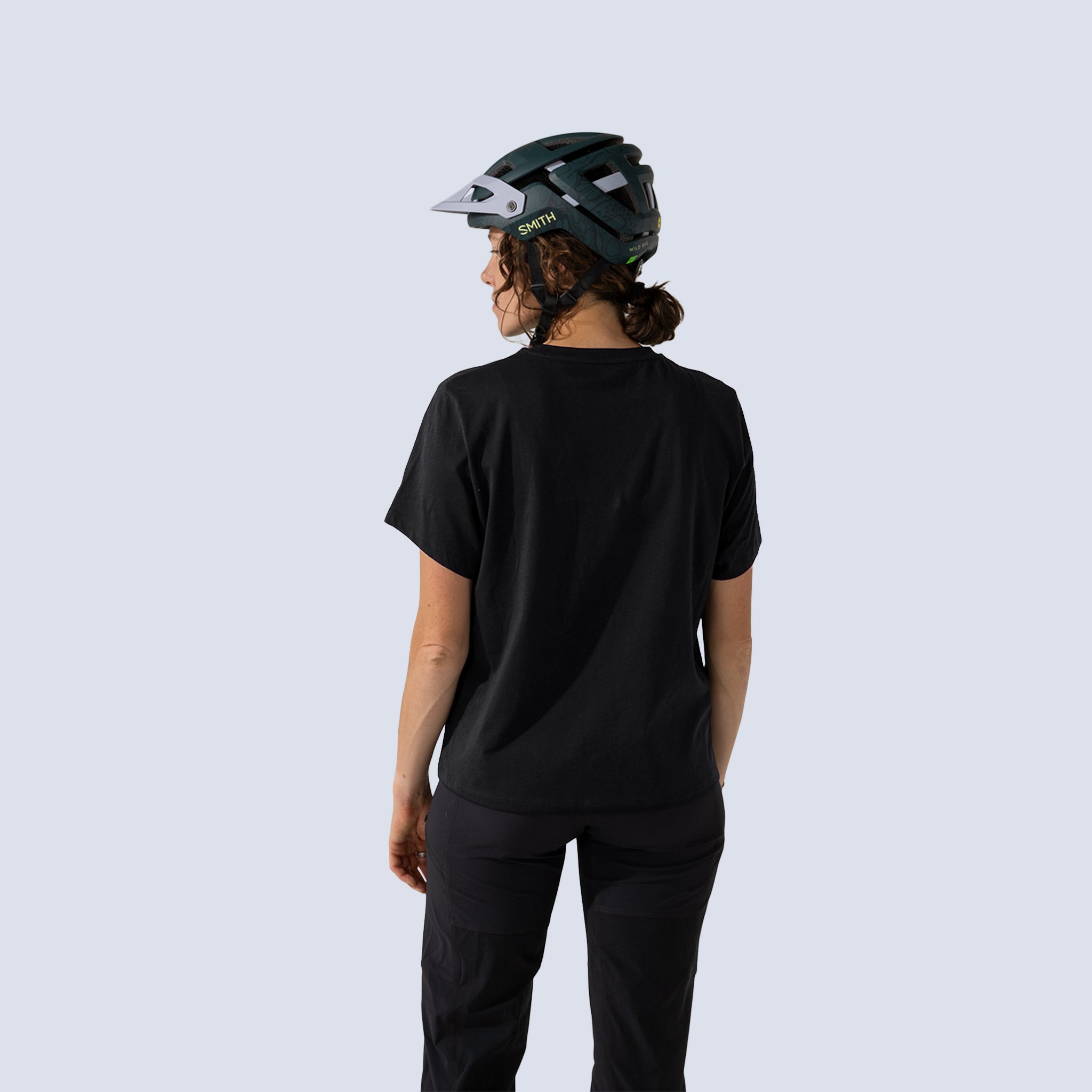 Woman wearing black t shirt, back view