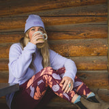 Woman wearing merino wool leggings drinking coffee