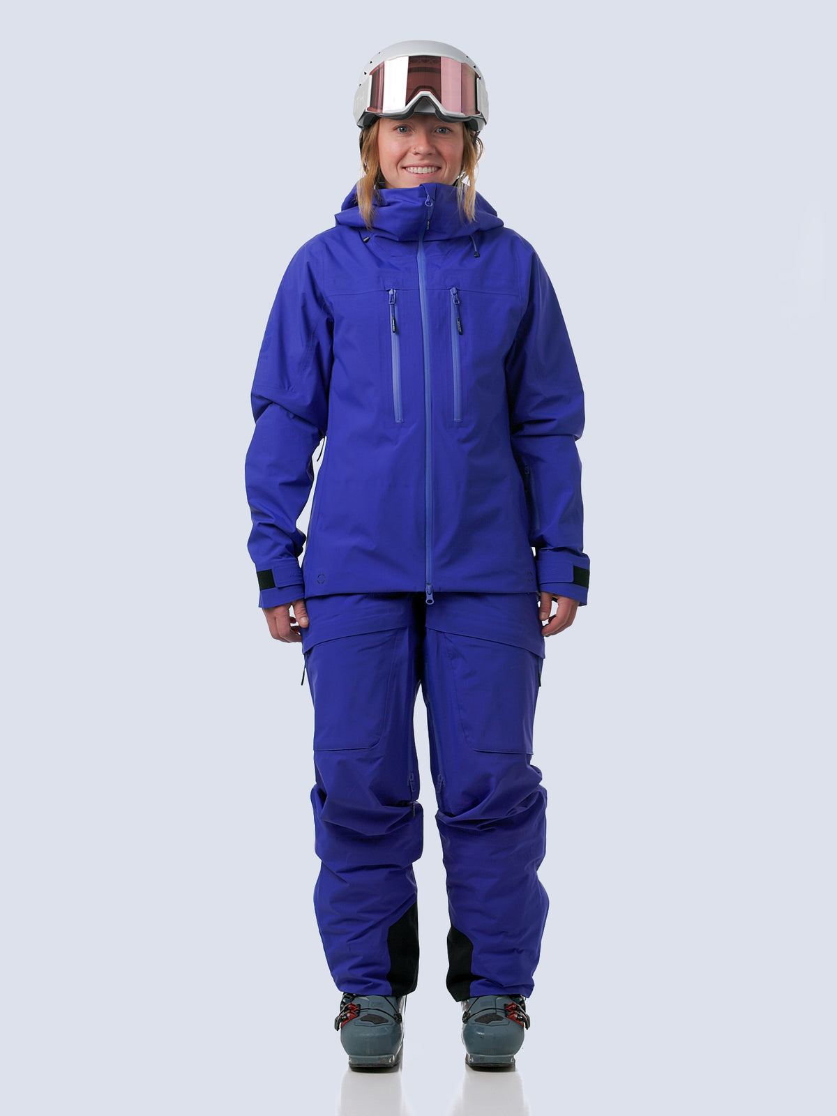 Woman wearing heyburn kit in lapis, walking into frame, turning and walking out