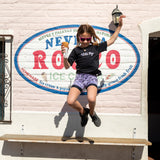 Girl jumping with  ice cream cone