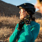 Woman buckling bike helmet wearing galena gel bike gloves