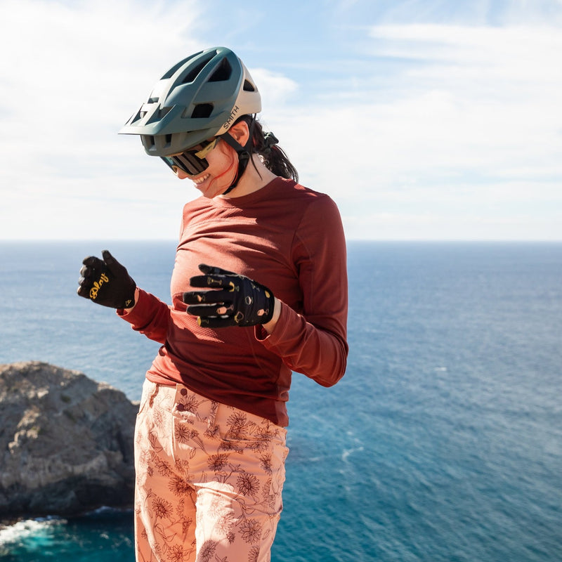 Woman mountain biking near the ocean
