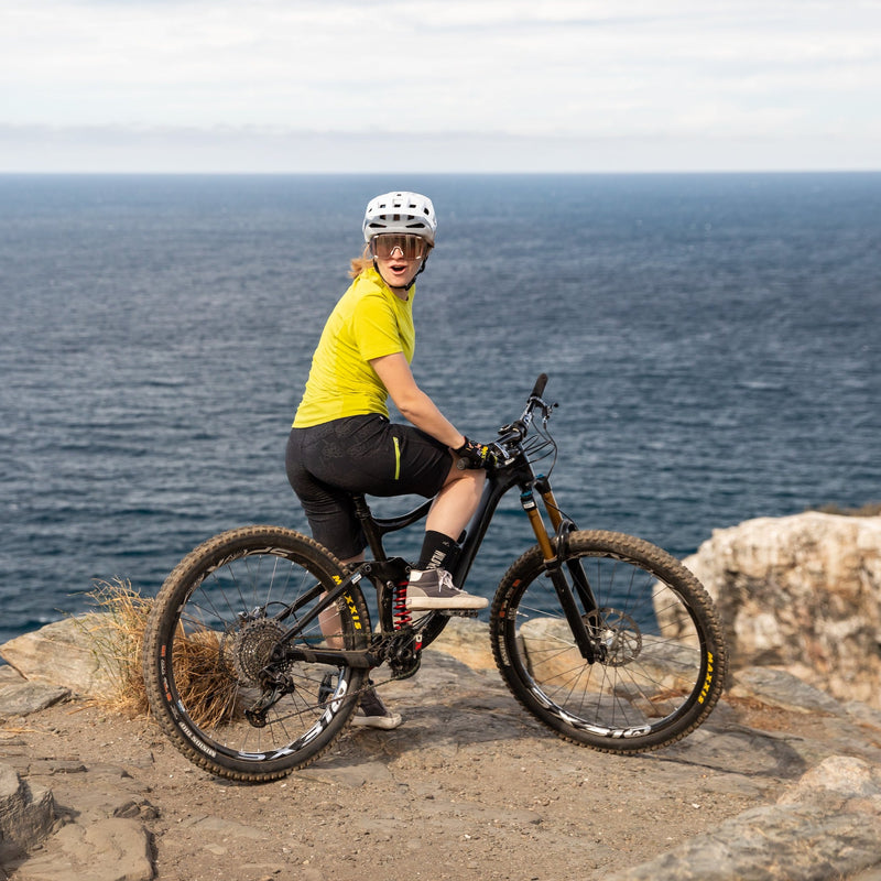Woman biking at the ocean in freel bike shorts