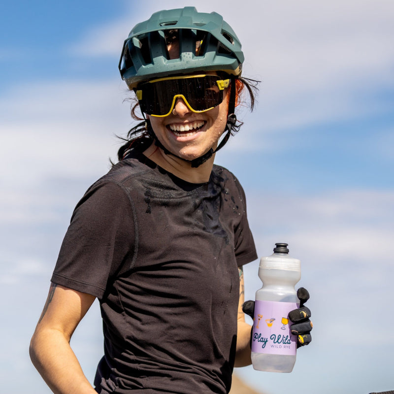 Woman drinking out of water bottle during bike ride