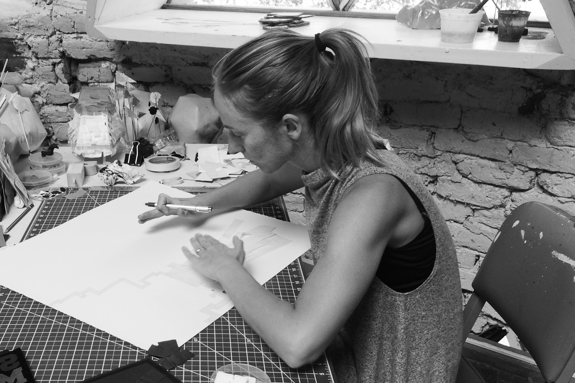 Lindsay Jones illustrating on paper in her studio