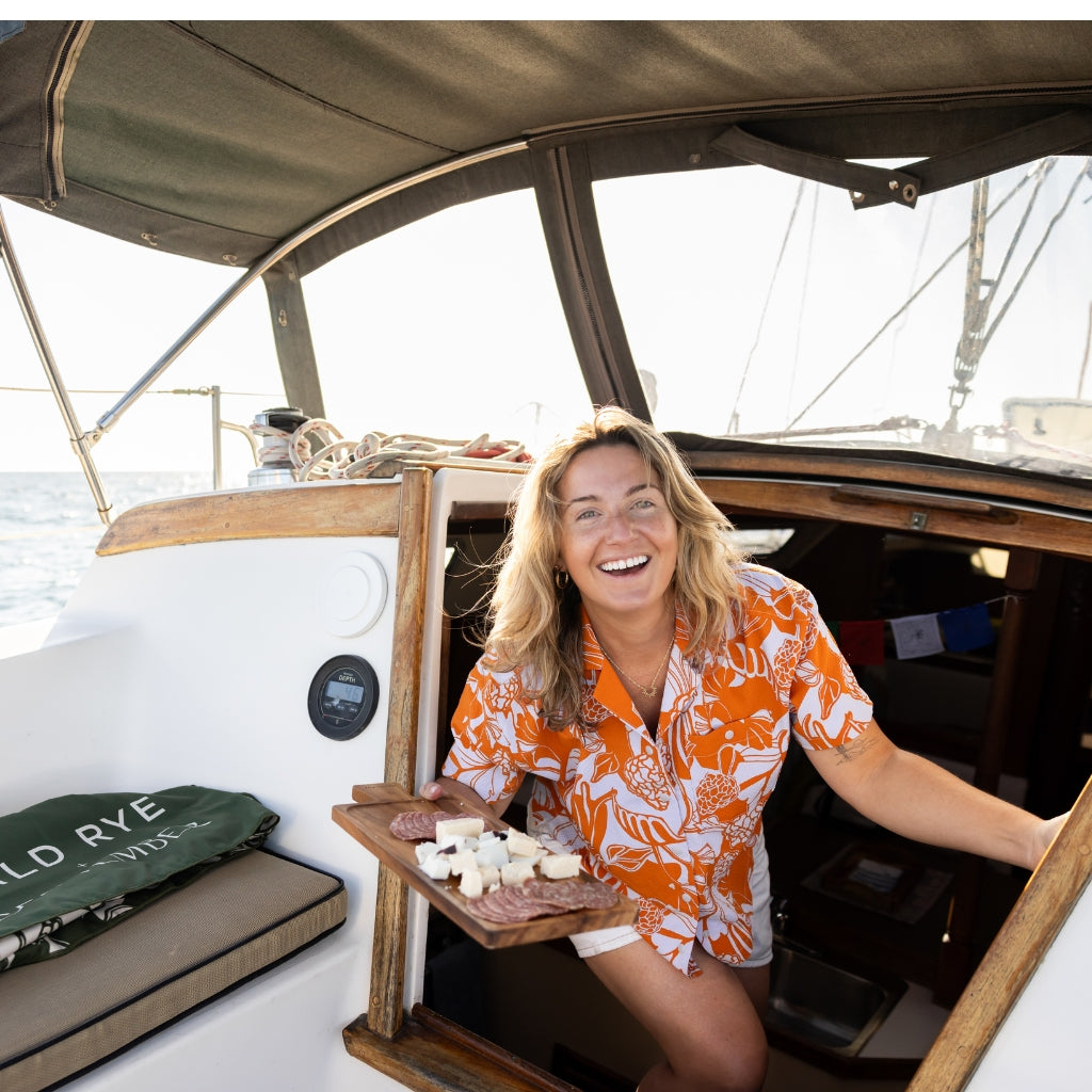 [Sedona Morchella] Woman holding charcuterie board on sailboat 