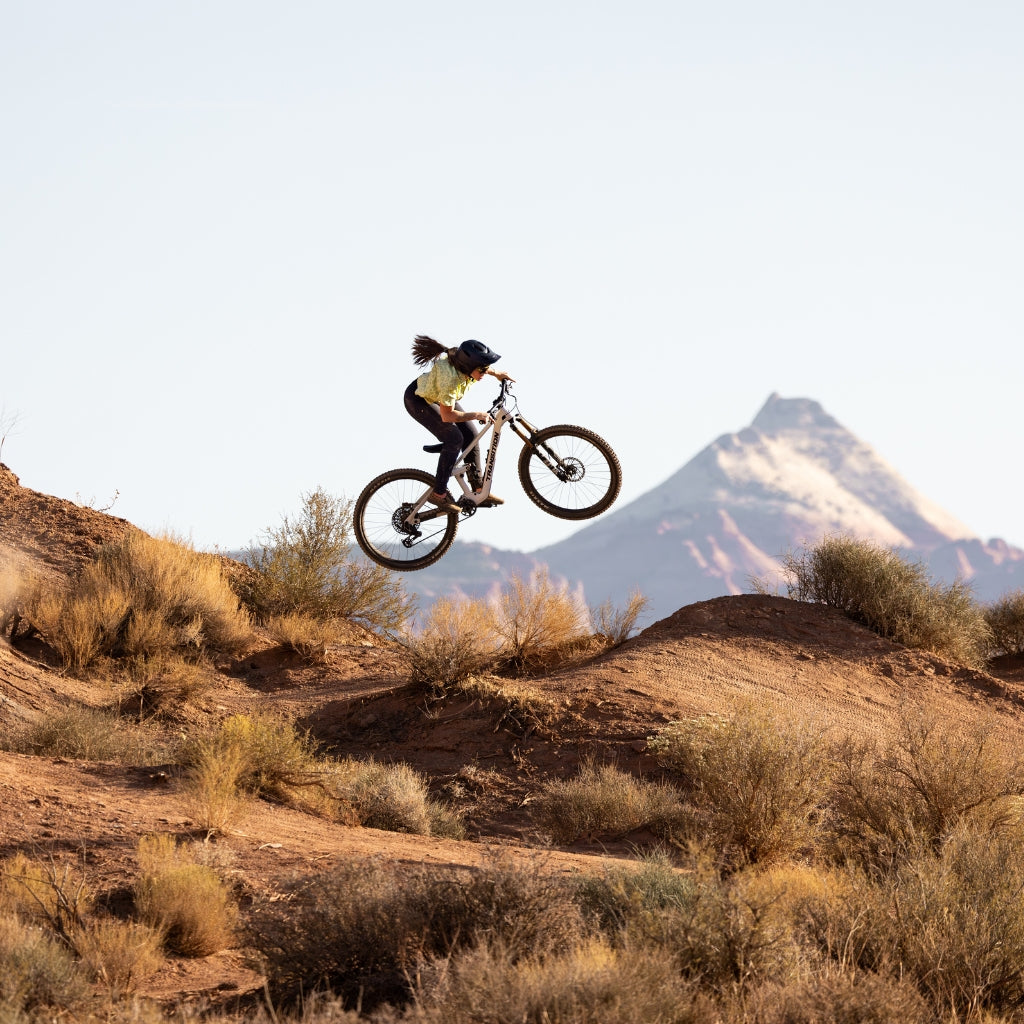 [Matcha Meowww] Woman going over a jump on a mountain bike in Utah