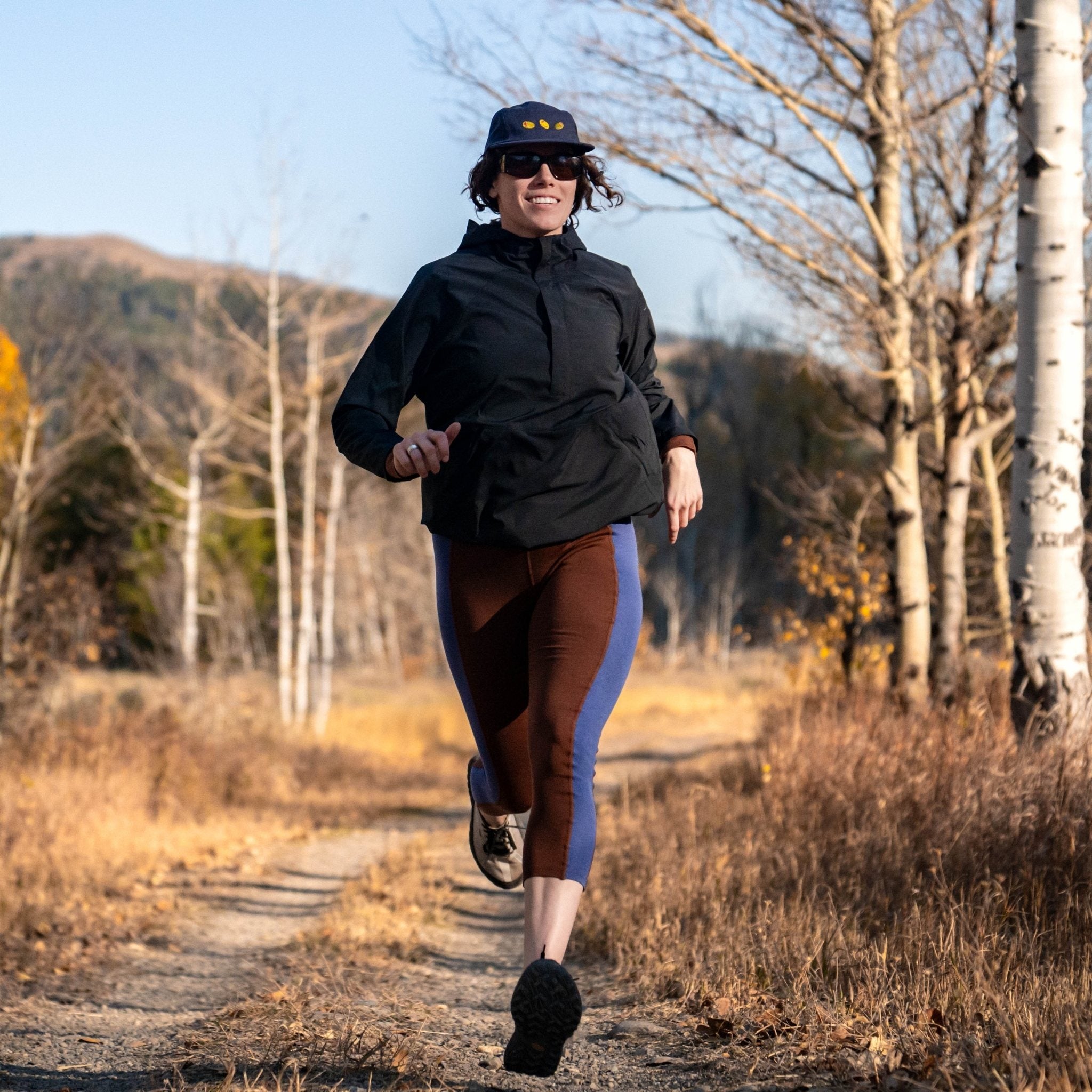 [Chestnut Storm] Woman running towards camera with a fall foliage background