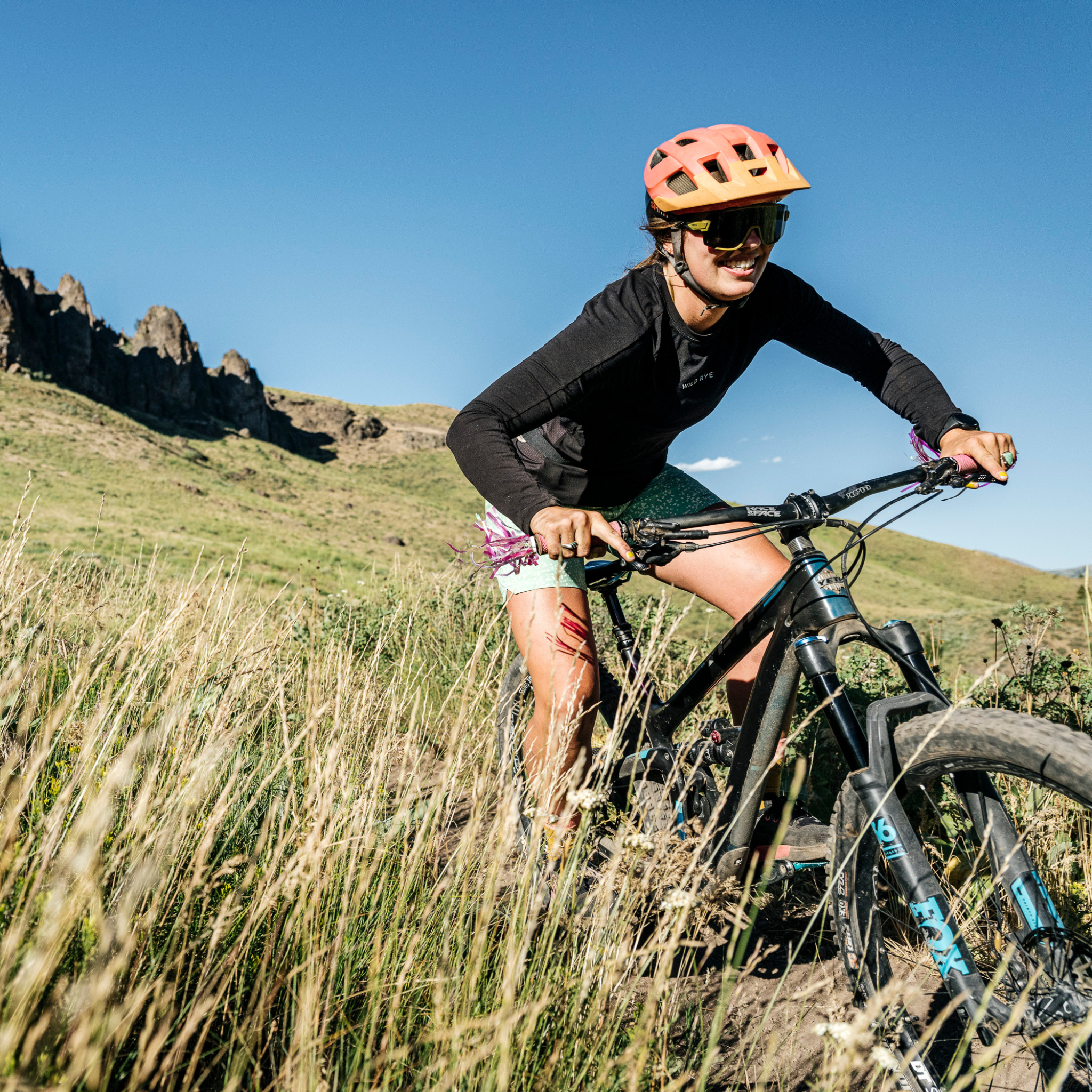 Woman biking downhill in Holly Jersey