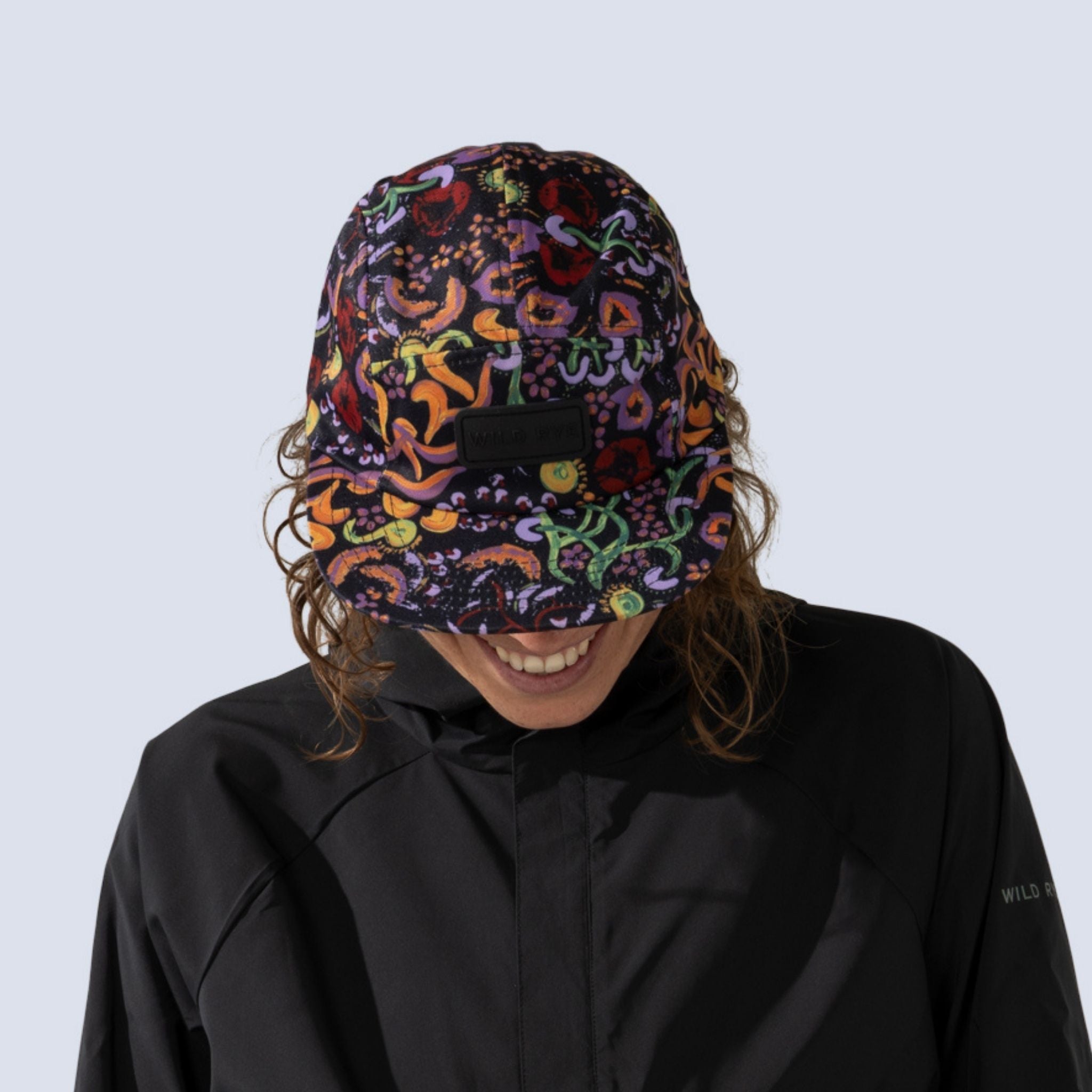 [Understory] Woman wearing black baseball hat with colorful deep sea inspired print