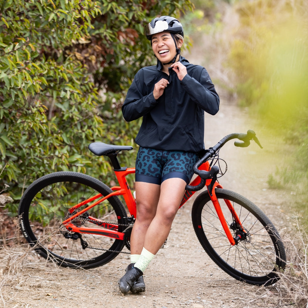 [Spruce Meowww] woman wearing Eleanor Chammy Spruce leaning against bike