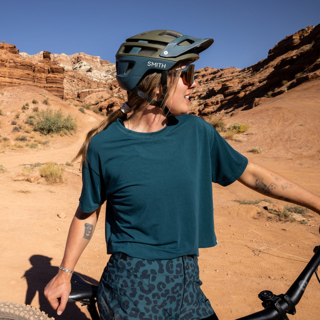 [Shaded Spruce] Woman mountain biking in the Utah desert