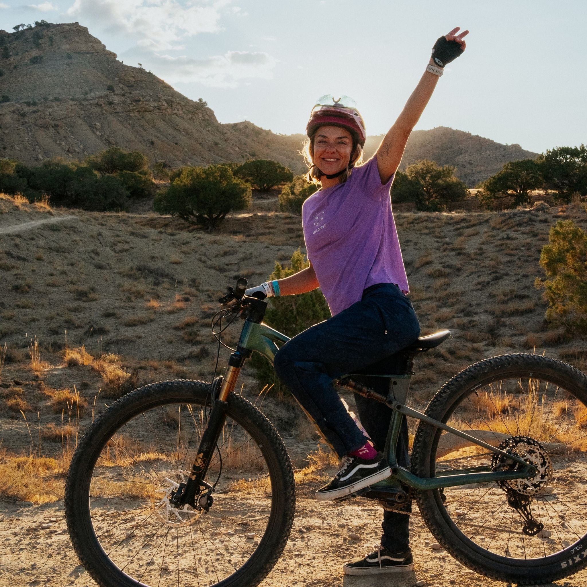 Person on a mountain bike in a desert landscape with mountains in the background