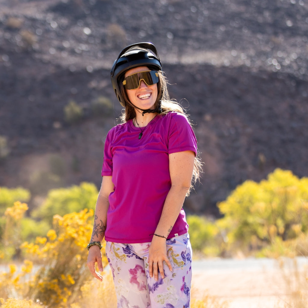 [Aster] Woman smiling after mountain biking