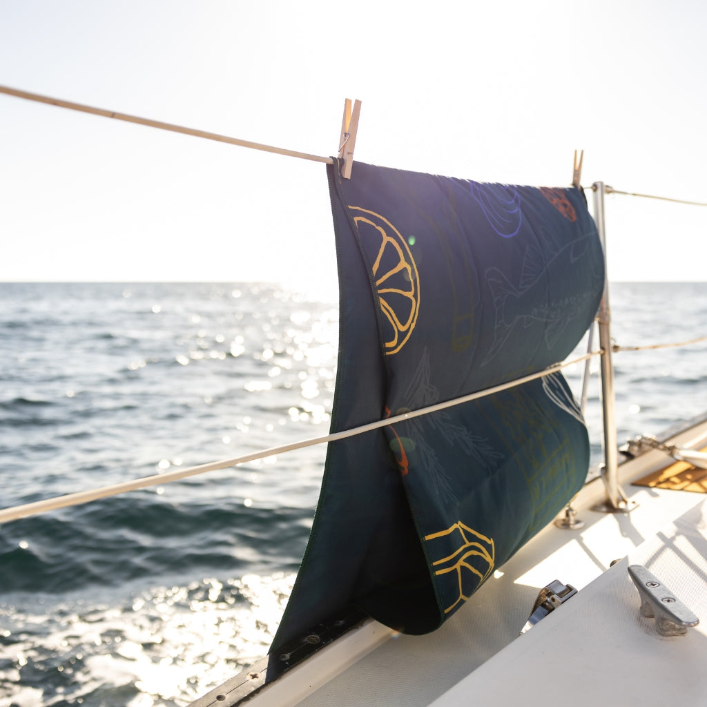 [Antipasto] Camp towel hanging over the side of a sail boat