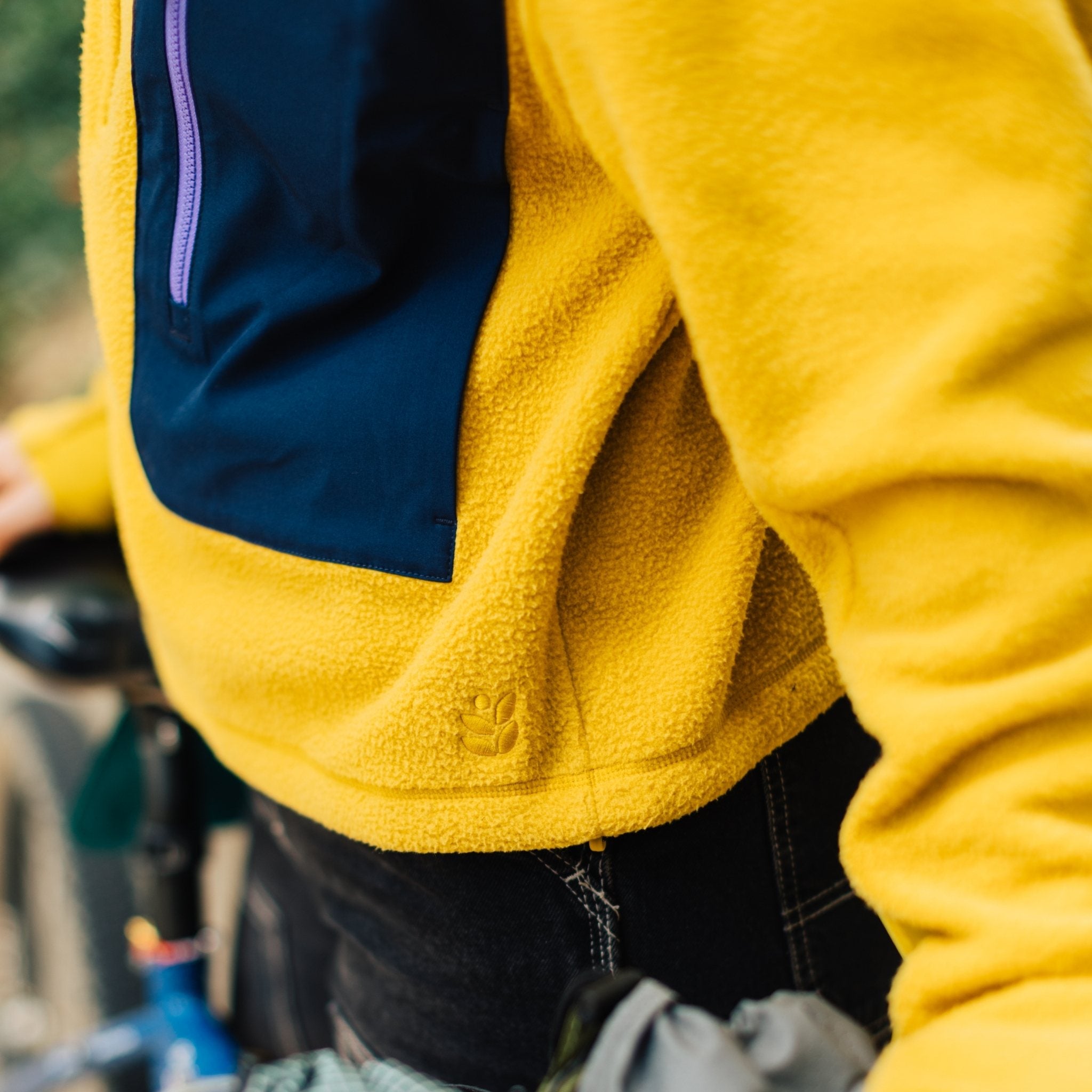 [Saffron] Hem detail shot of yellow fleece jacket