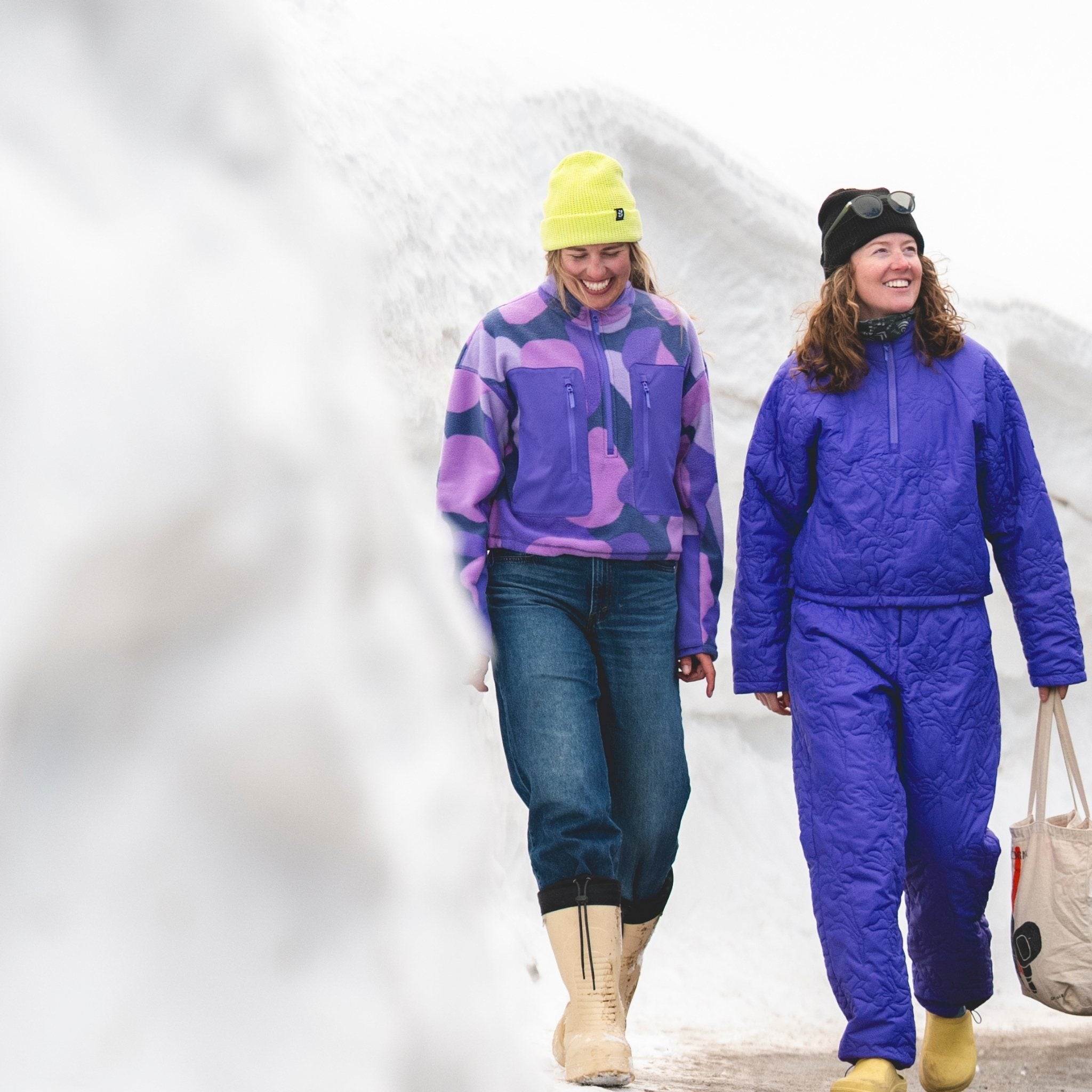 [Grape Expectations] Two women walking together and smiling in the snow