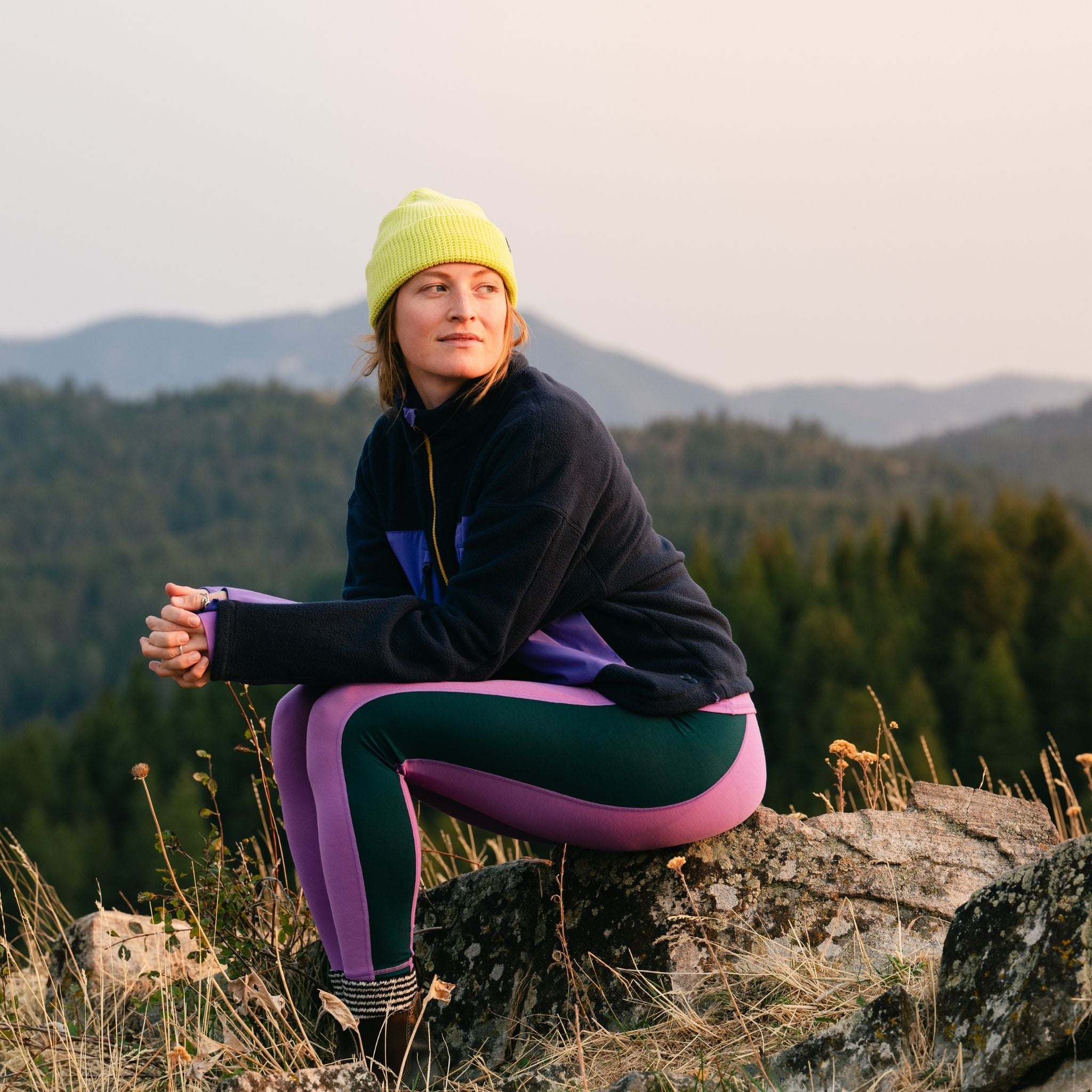 [Amethyst Blocked] Person sitting on a log with a scenic background of trees and mountains