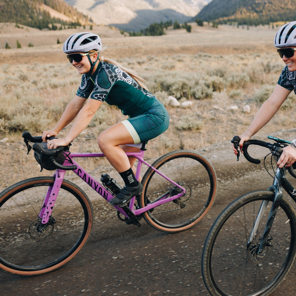 [Spruce Roots] woman riding gravel bike in smith x wild rye gravel kit