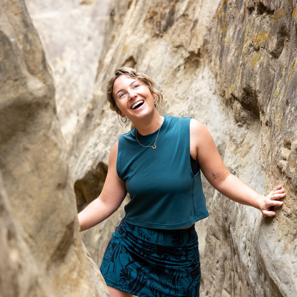 [Shaded Spruce] Woman hiking through slot canyon