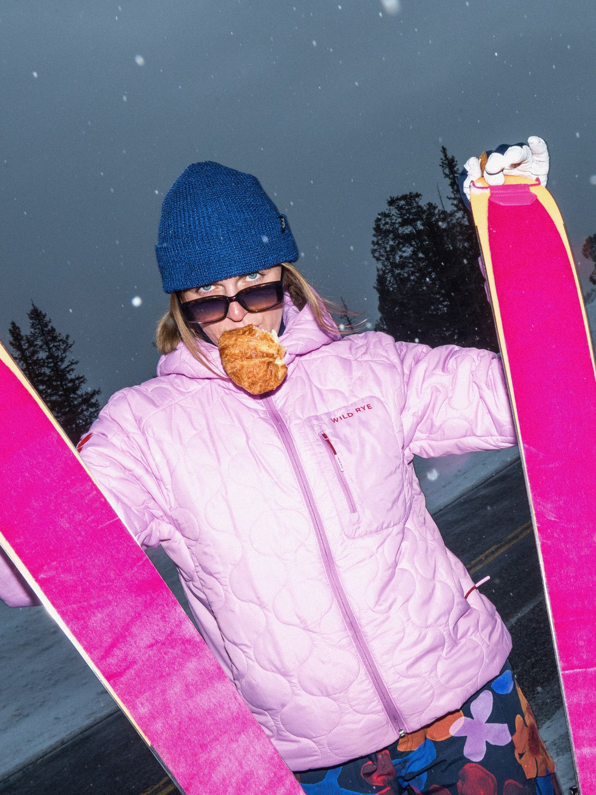 [Orchid] Woman skiing in an orchid pink Braxon Hoodie on a snowy mountain