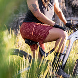 Freda 7" woman wearing freda Bike Short llamas mahogany on bike