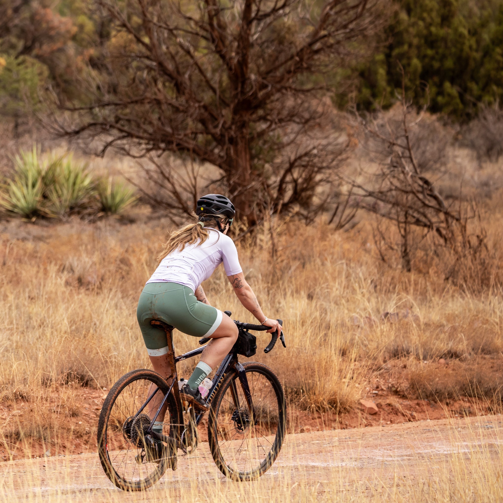 [Slate Green - Mist] Woman Riding Gravel Bike in Desert