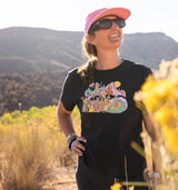 Woman standing in the desert wearing changemaker tee