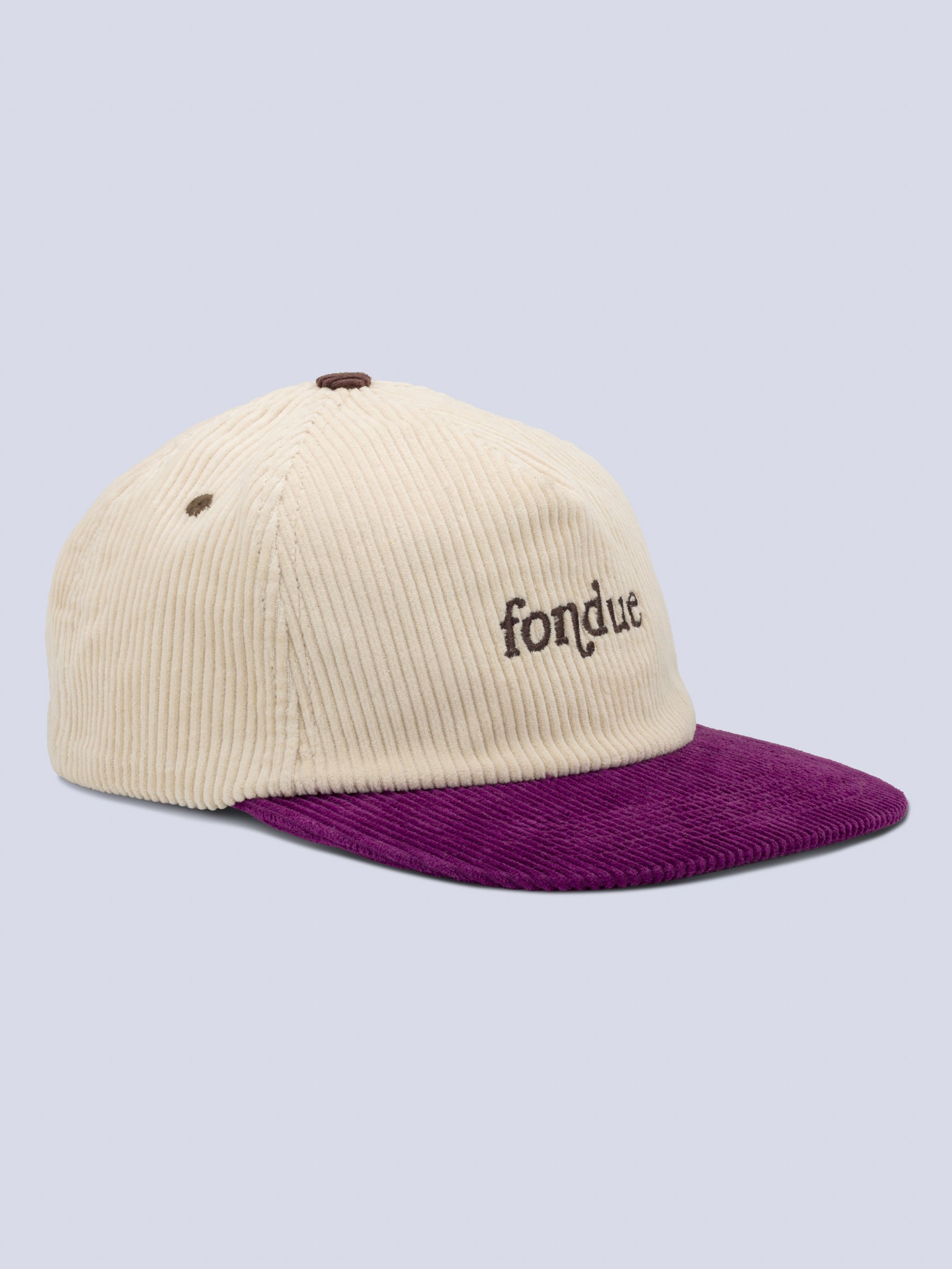 [Fondue] Roy Hat in cream corduroy with a purple brim and "fondue" embroidered on the front, shown at an angle against a light background