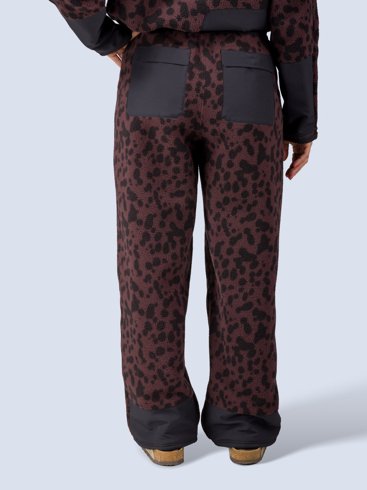 [Dapple] Close-up back view of the Banner Pant in brown leopard-print fleece, showing the two back patch pockets