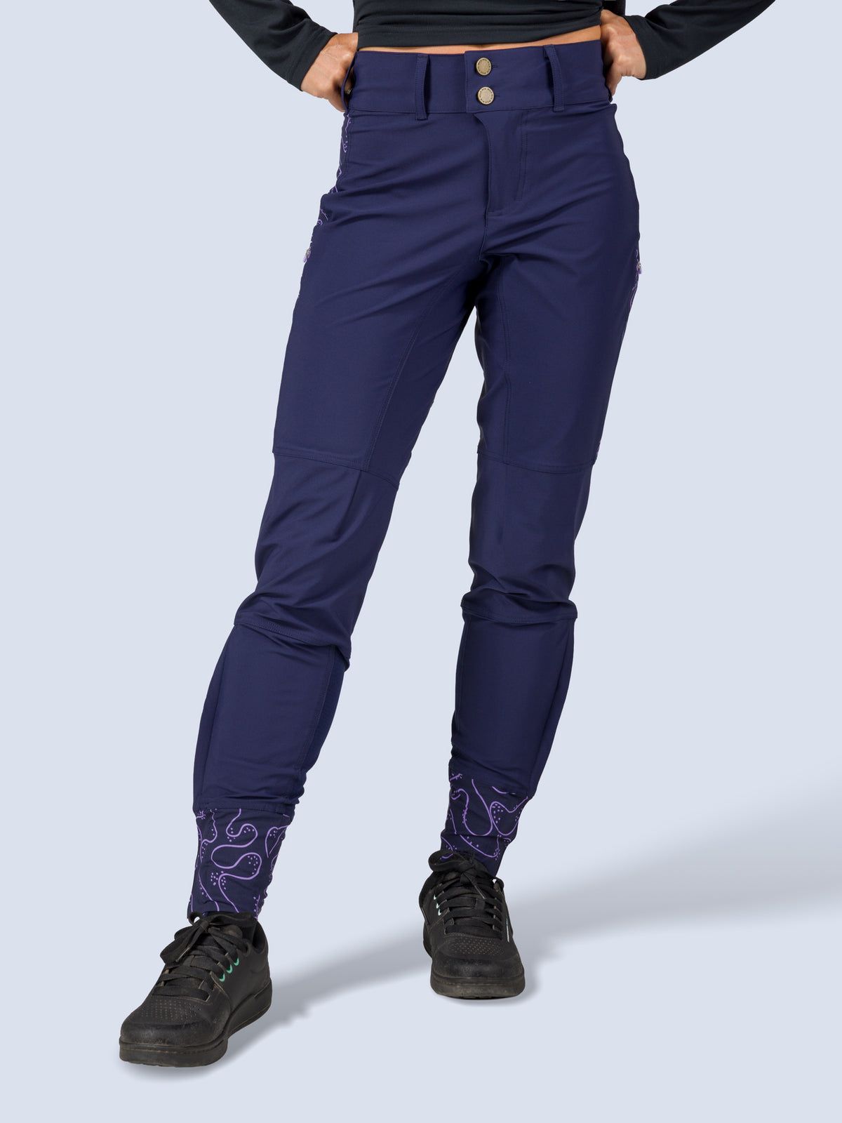 [Abyss Reef] Close-up front view of the Freyah Bike Pant's high-rise waistband with snap closure in navy