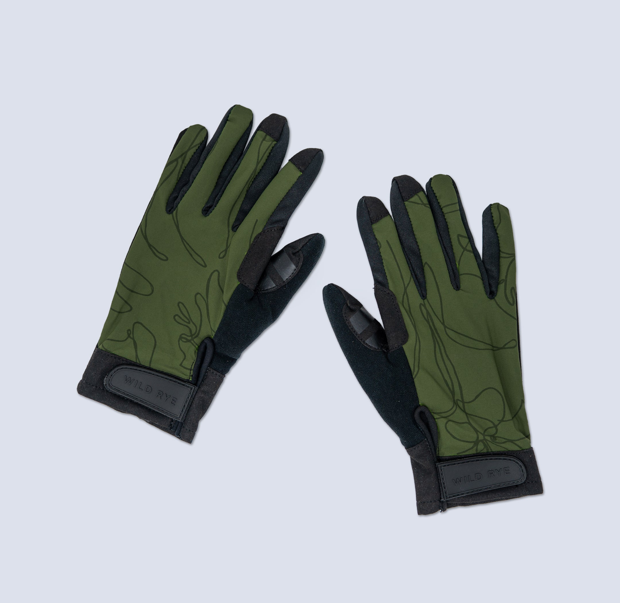Pair of green and black gloves on a light gray background