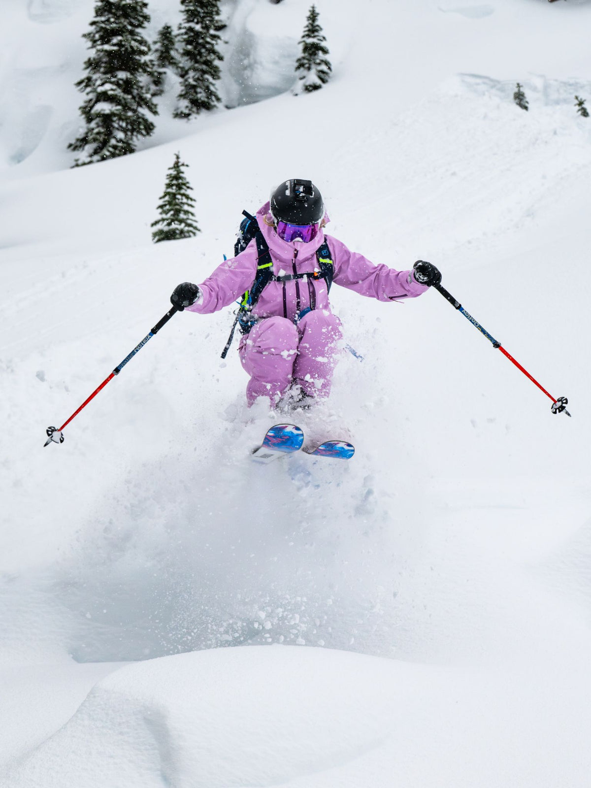 [Orchid] Woman skiing fresh powder in an orchid pink Heyburn 3L Jacket