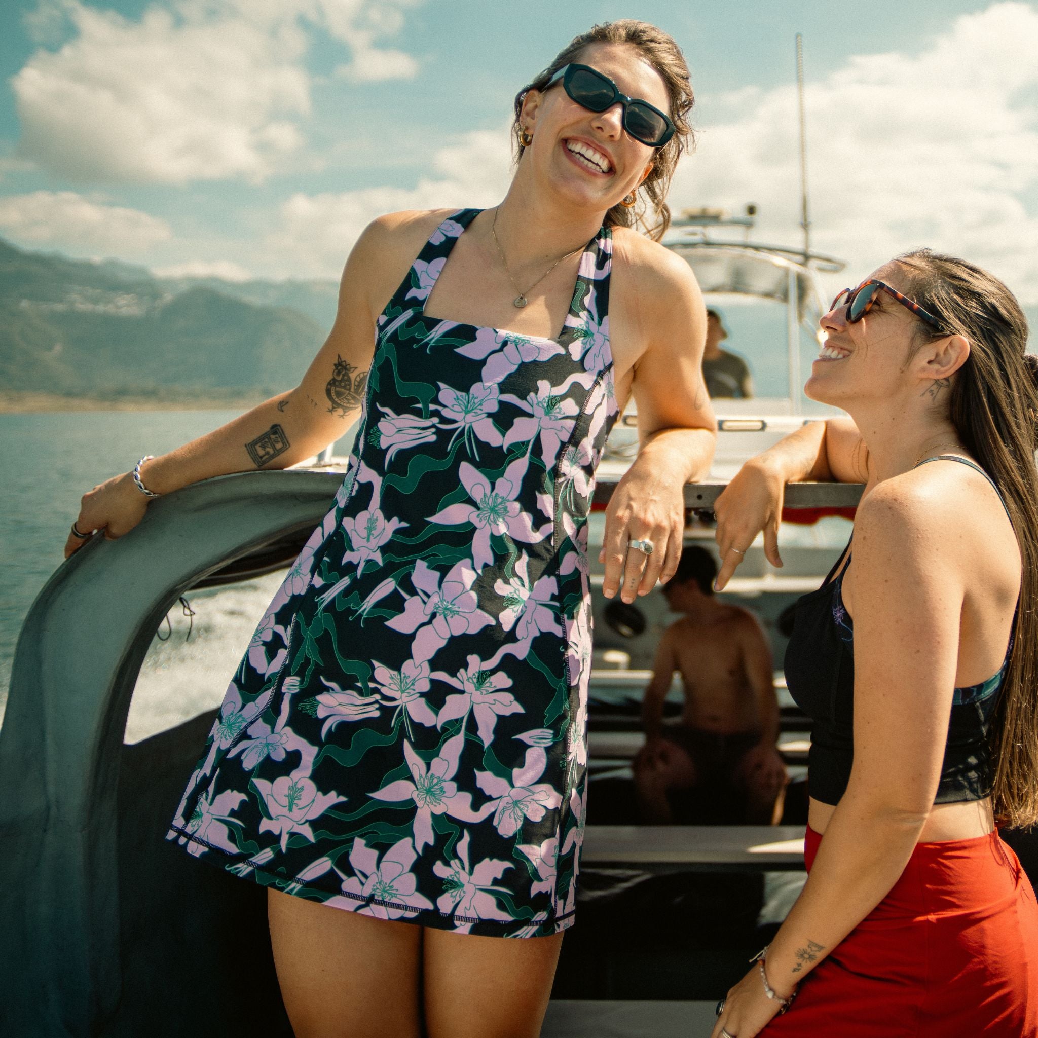 [Black Aquila Bloom] Two women on a boat with a scenic background
