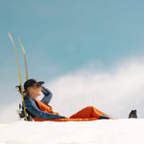 [Retro Riptide Bluebell] woman leaning back against skis in the snow