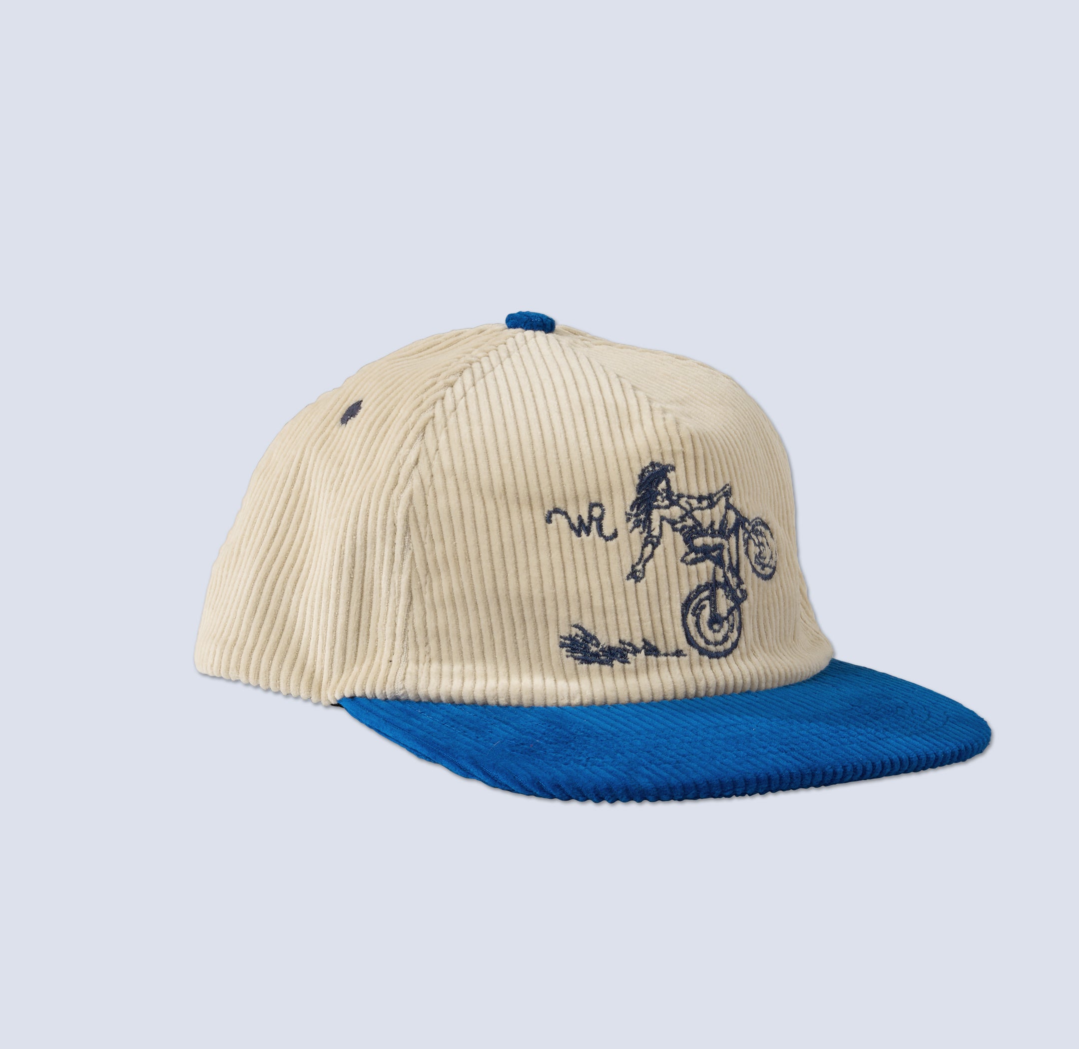 a Beige and blue corduroy cap with stitched mountain biker design