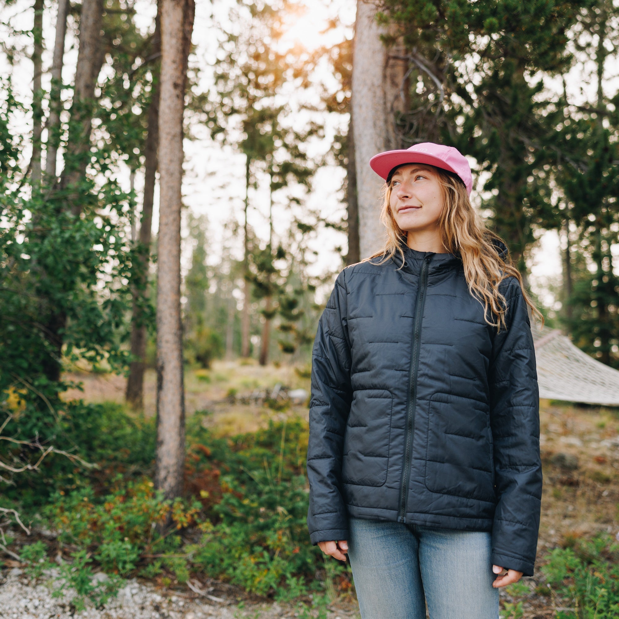 [Black] Woman wearing black insulated jacket with pink hat