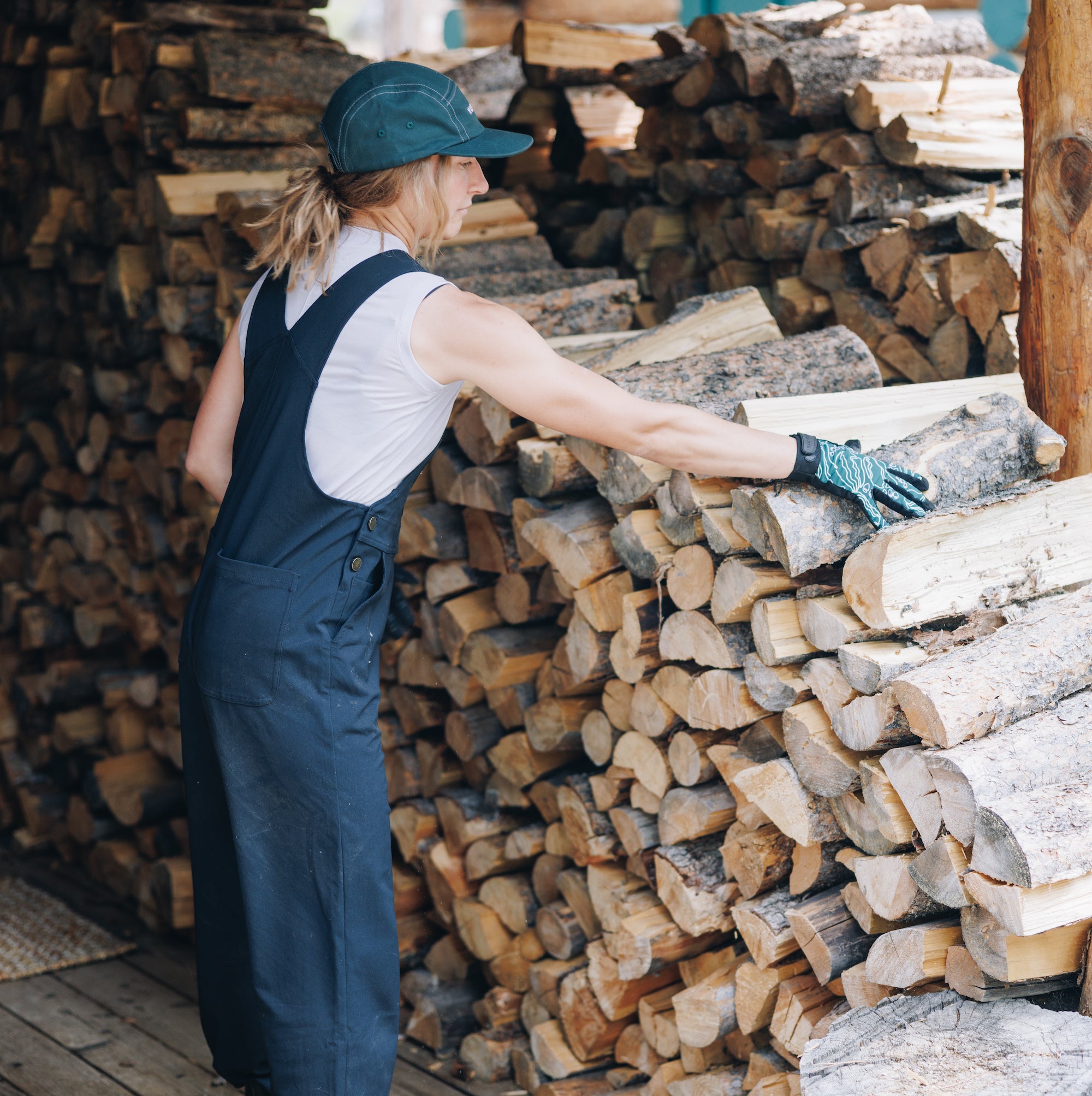 [Black] Woman stacking logs