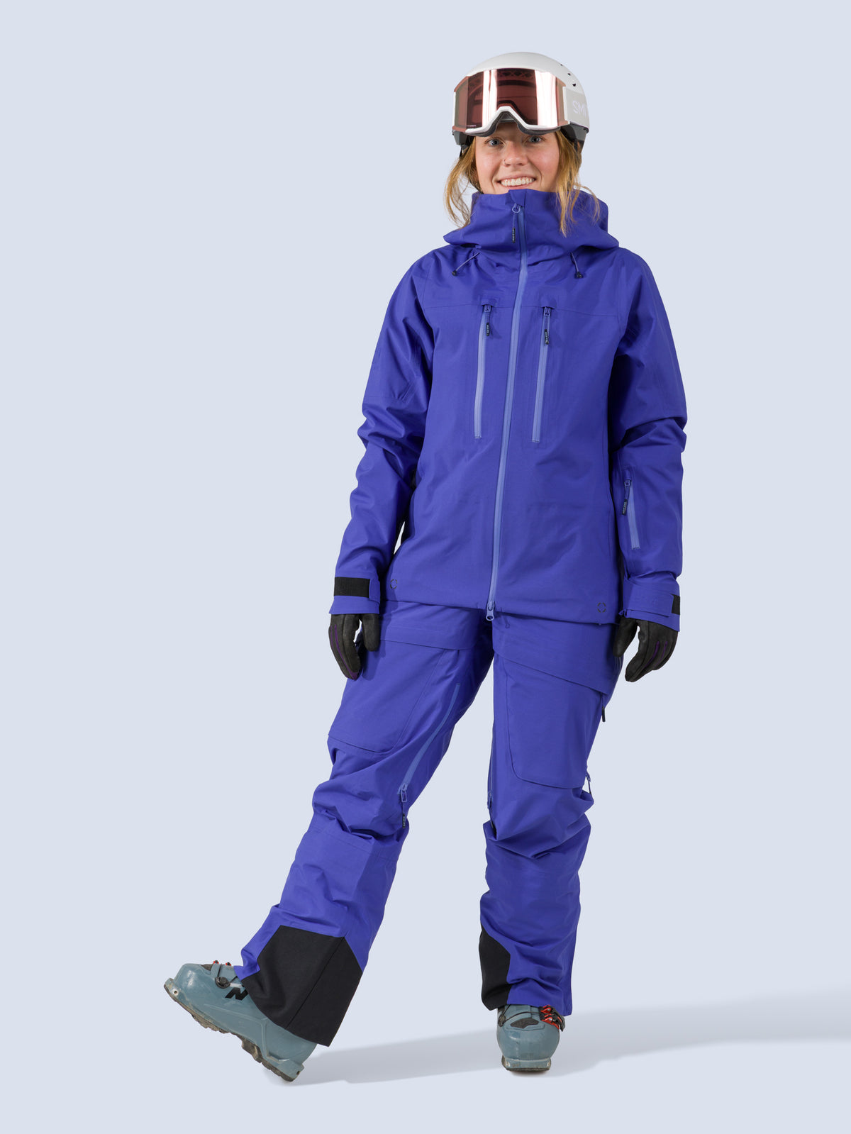 [Lapis] Heyburn 3L Bib in lapis blue, styled with the Heyburn 3L Jacket, on model front full body view