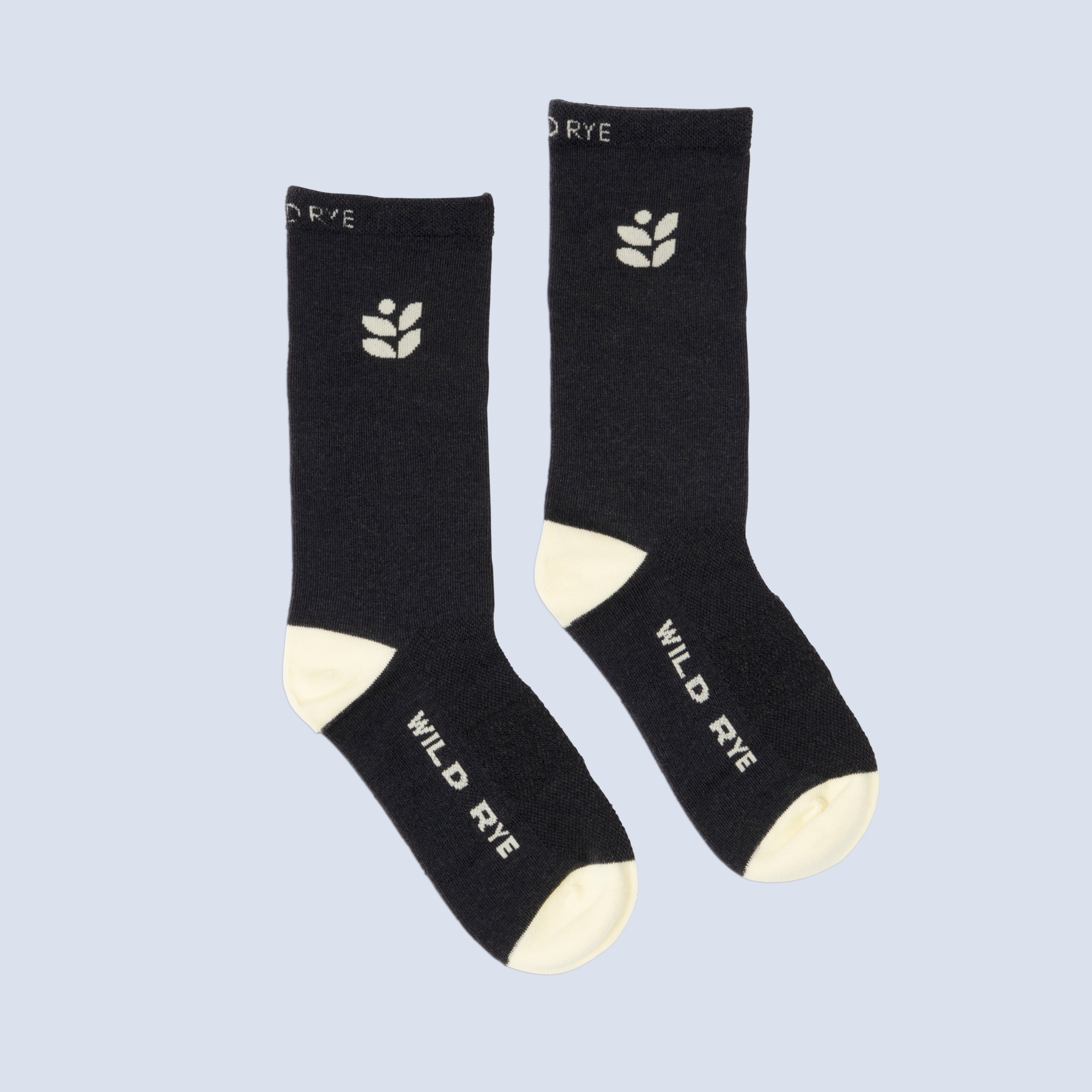 [Butter Logo] Wild Rye black bike socks with butter color logo and "Wild Rye" text at sole