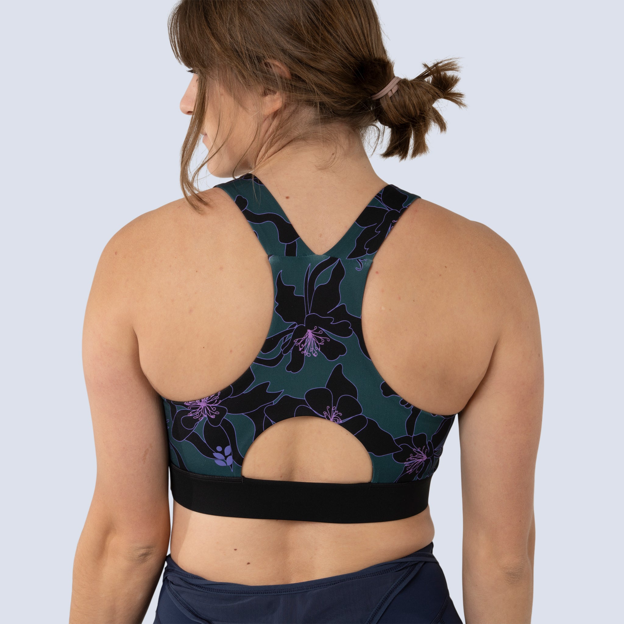 [Spruce Aquila Bloom] Lucille sports bra in green with black floral pattern, on model back crop view