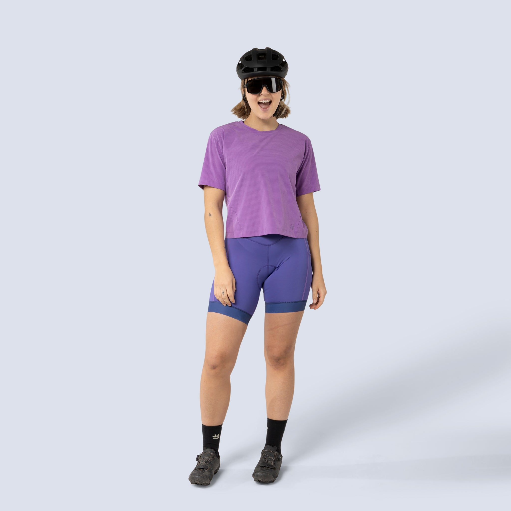 [Iris] Billie Stash Bib in Iris, on model front full body view with purple shirt