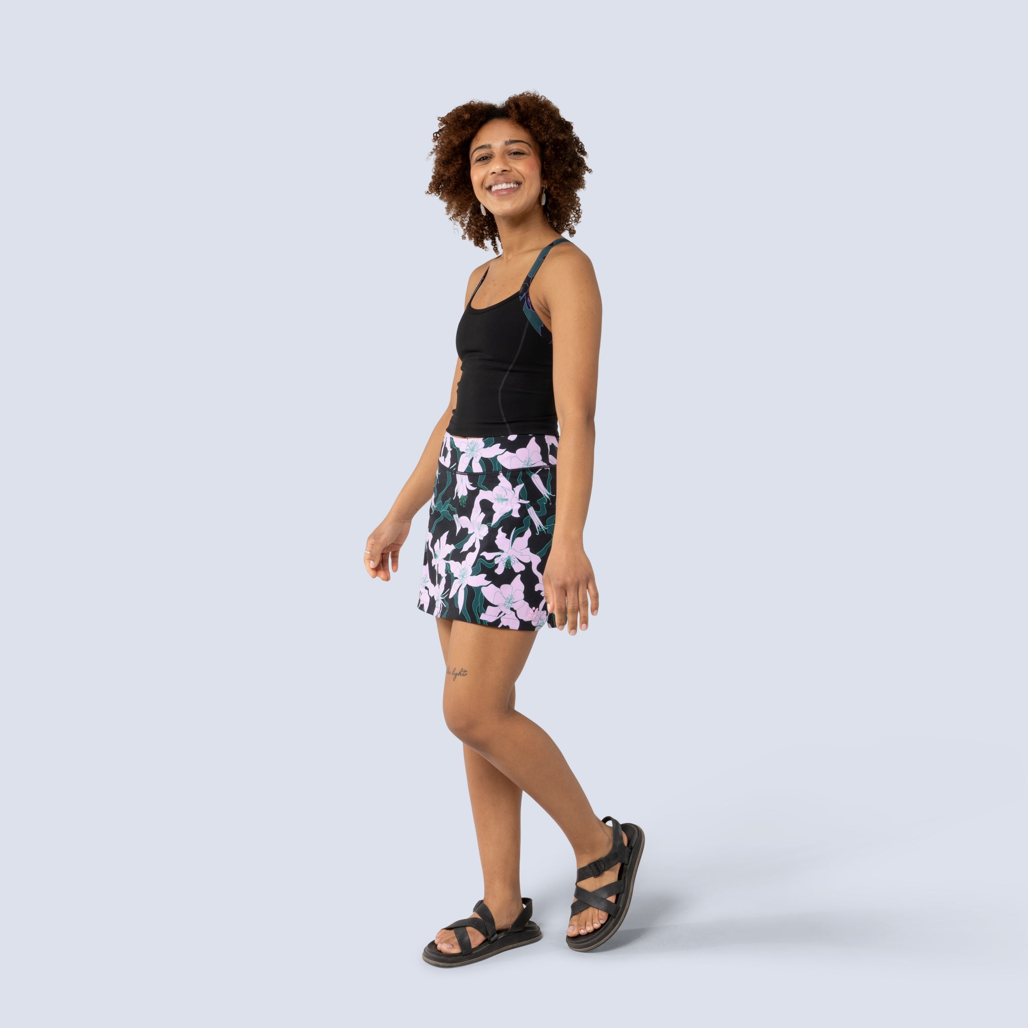 [Black Aquila Bloom] Parker Skort in black with pink floral pattern, on model front full body view