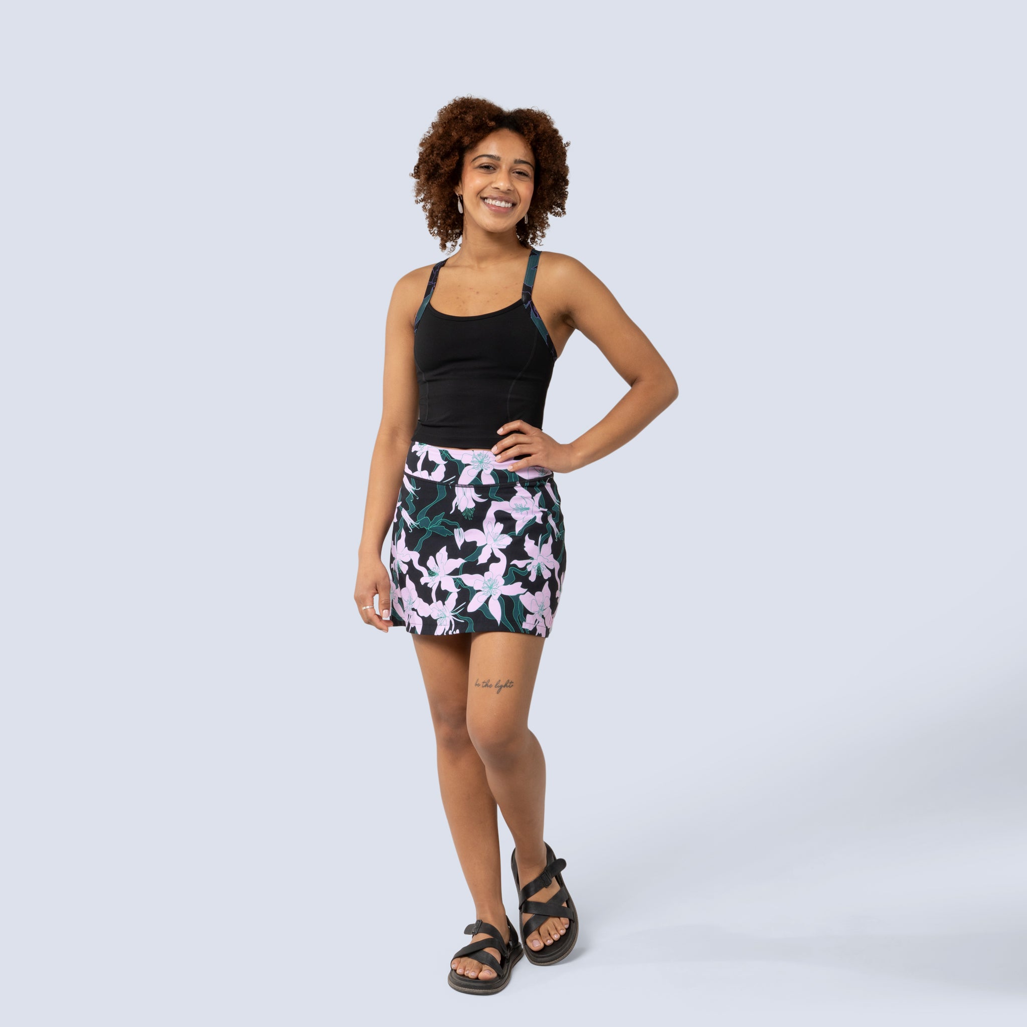 [Black Aquila Bloom] Parker Skort in black with pink floral pattern, on model front full body view