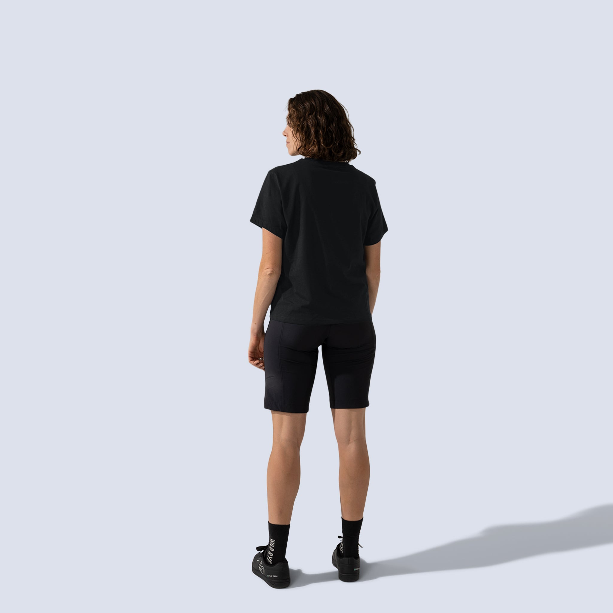 [Black] Freel 12" bike shorts in black, on model back full body view
